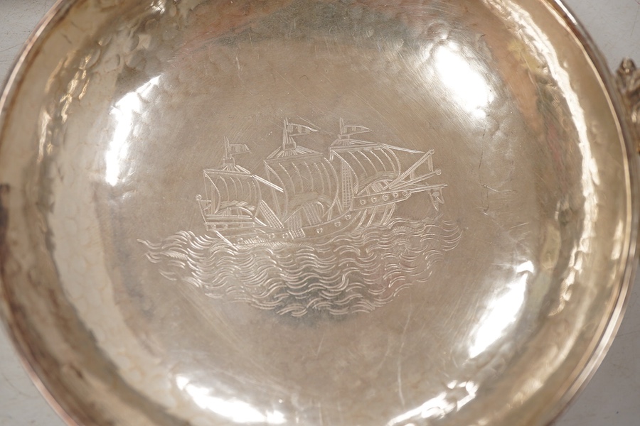 A pair of George V continental silver quaichs, with pierced lug handles and each engraved with a three-masted ship at sea, import marks for Berthold Hermann Muller, London, 1913, 17.3cm.